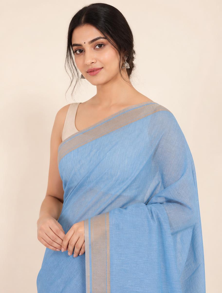 Woman in a light blue cotton saree for everyday wear
